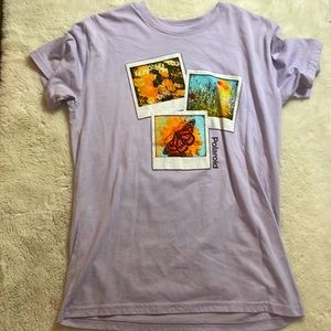 A  purple Polaroid shirt in women’s medium.